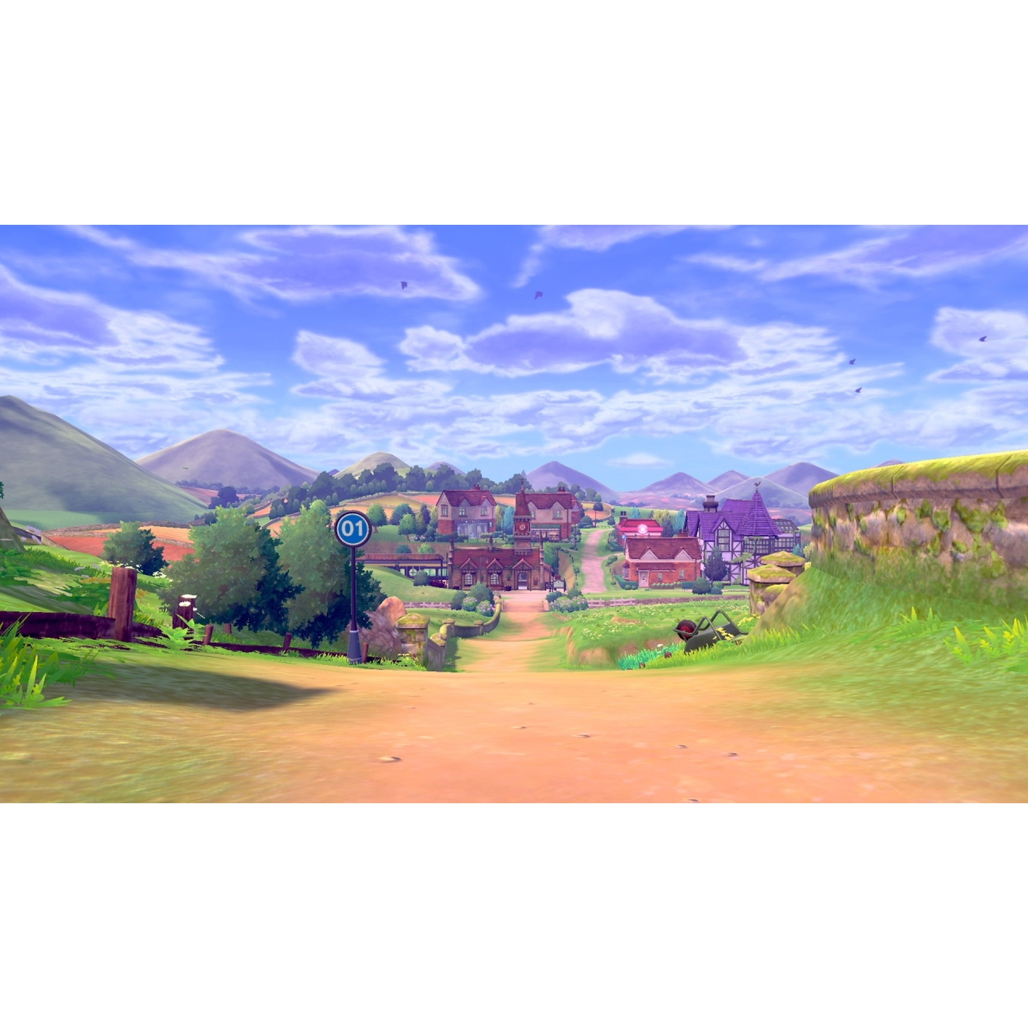 A rural town with houses, hills, and a blue sky with clouds.