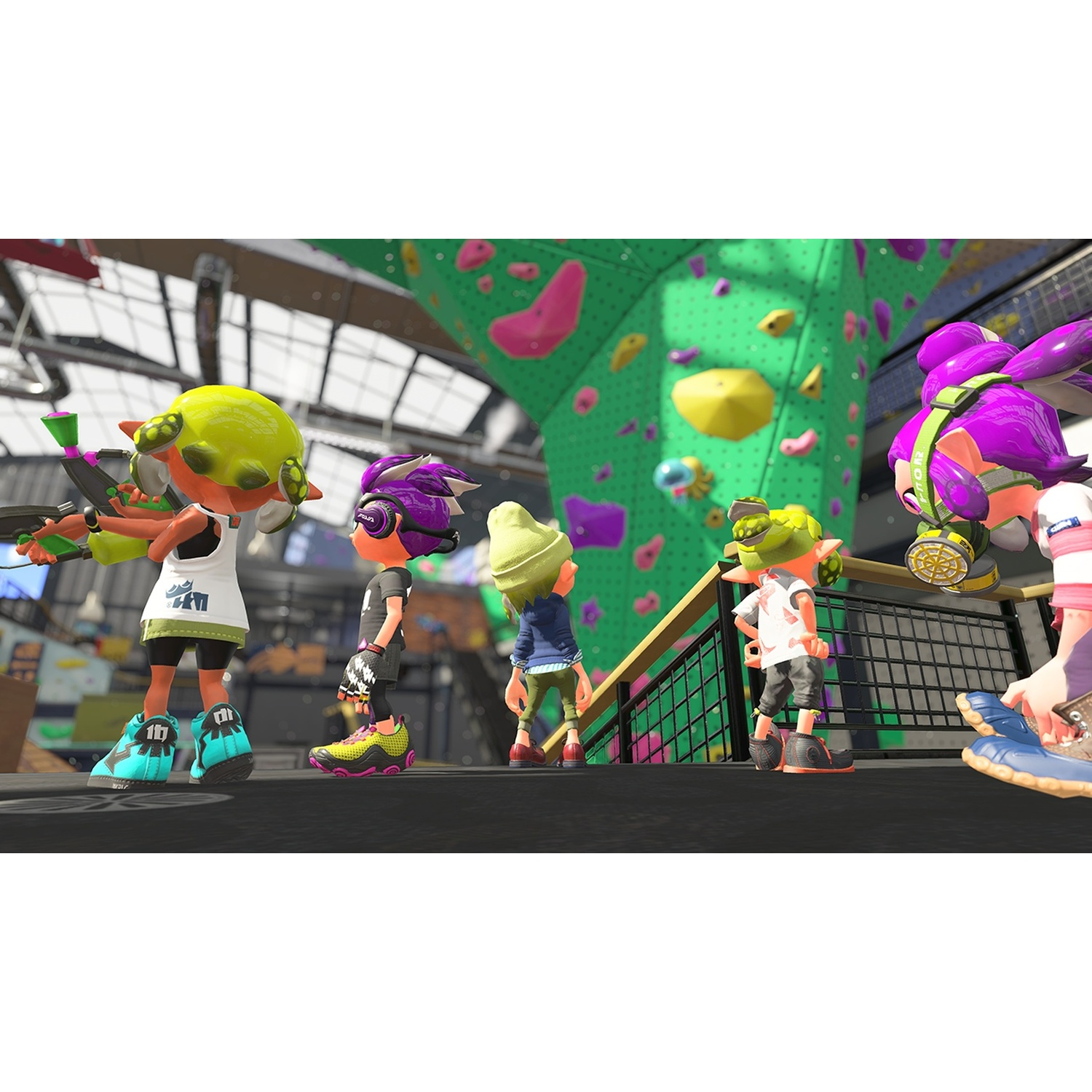 Five cartoon characters in colorful outfits stand on a platform near a green climbing wall.