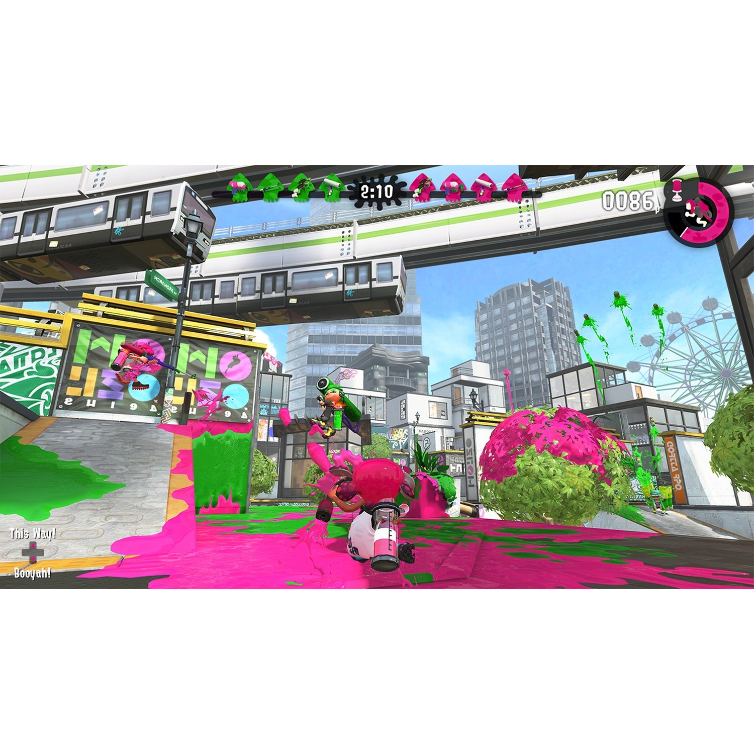 Players in pink and green with paint splatters in a city scene with an elevated train.