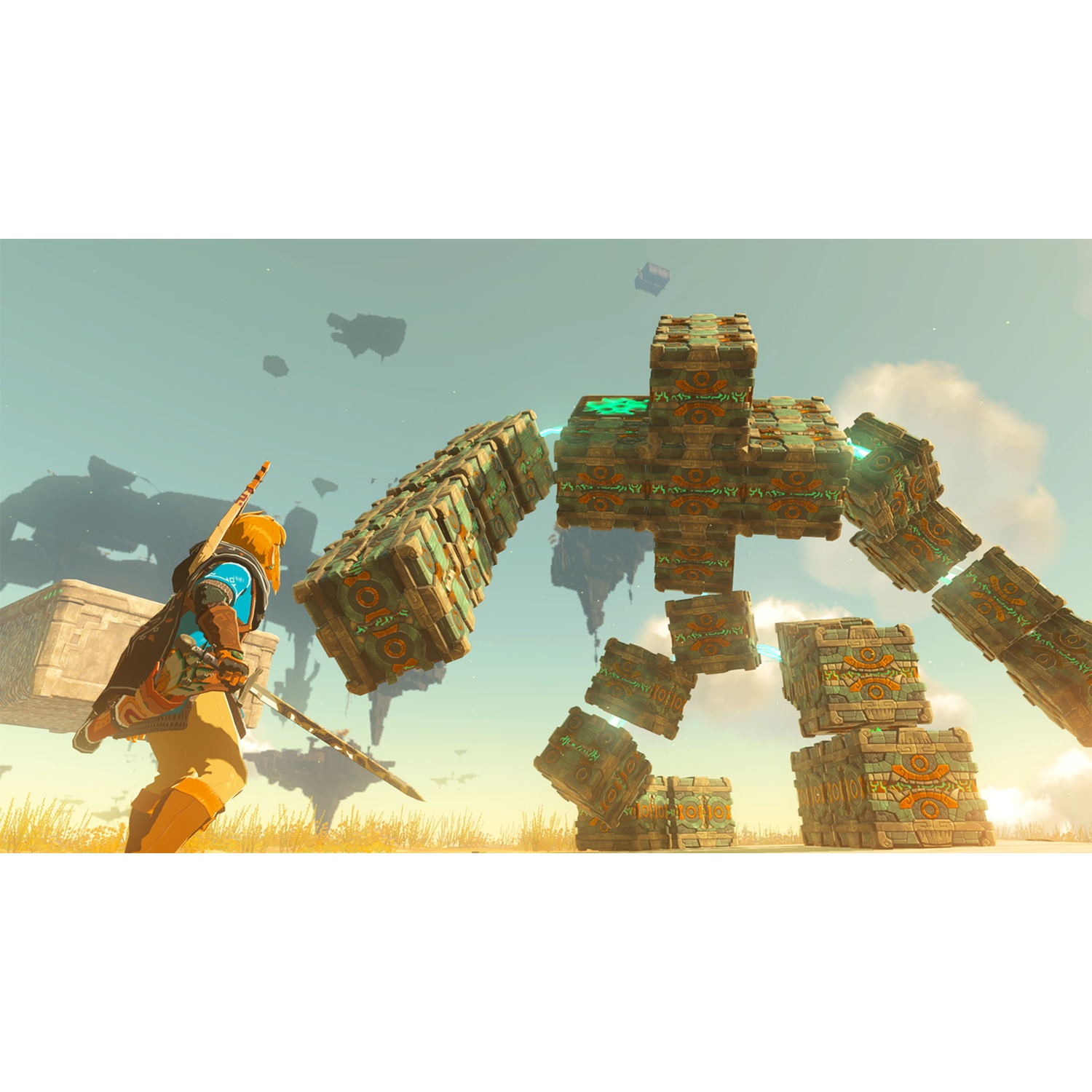 Link stands before a large stone robot in an open field under a blue sky.