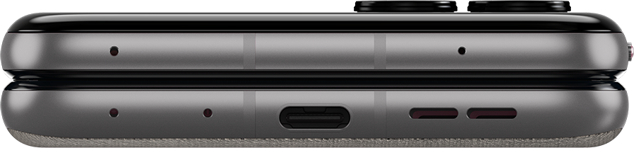 Szürke okostelefon alsó részének közelképe, USB-C porttal és hangszórórácsokkal.