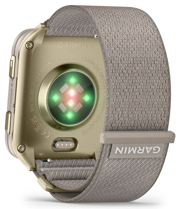 Tył złotego smartwatcha Garmin z czujnikami i szarym paskiem z tkaniny.