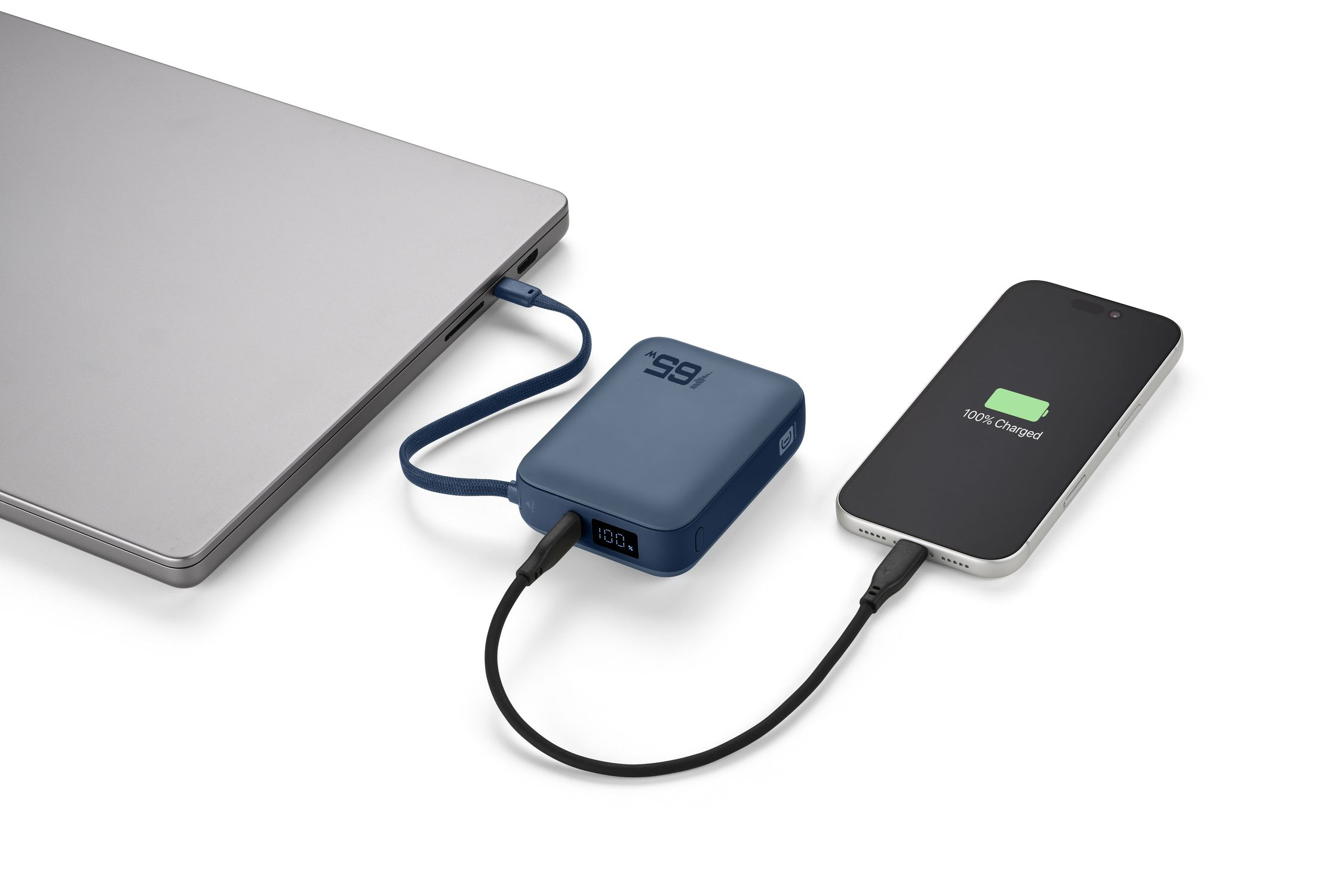 Un power bank azul carga un smartphone mientras es cargado por un portátil.
