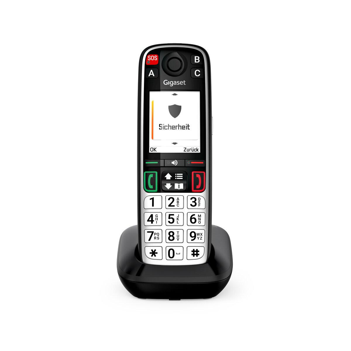 Ein schnurloses Gigaset-Telefon mit SOS-Taste und beleuchteter Tastatur ruht auf einer Ladestation.