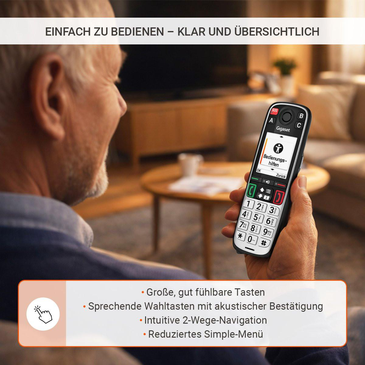 Mann hält ein Gigaset-Telefon mit großen Tasten und Hilfetext.