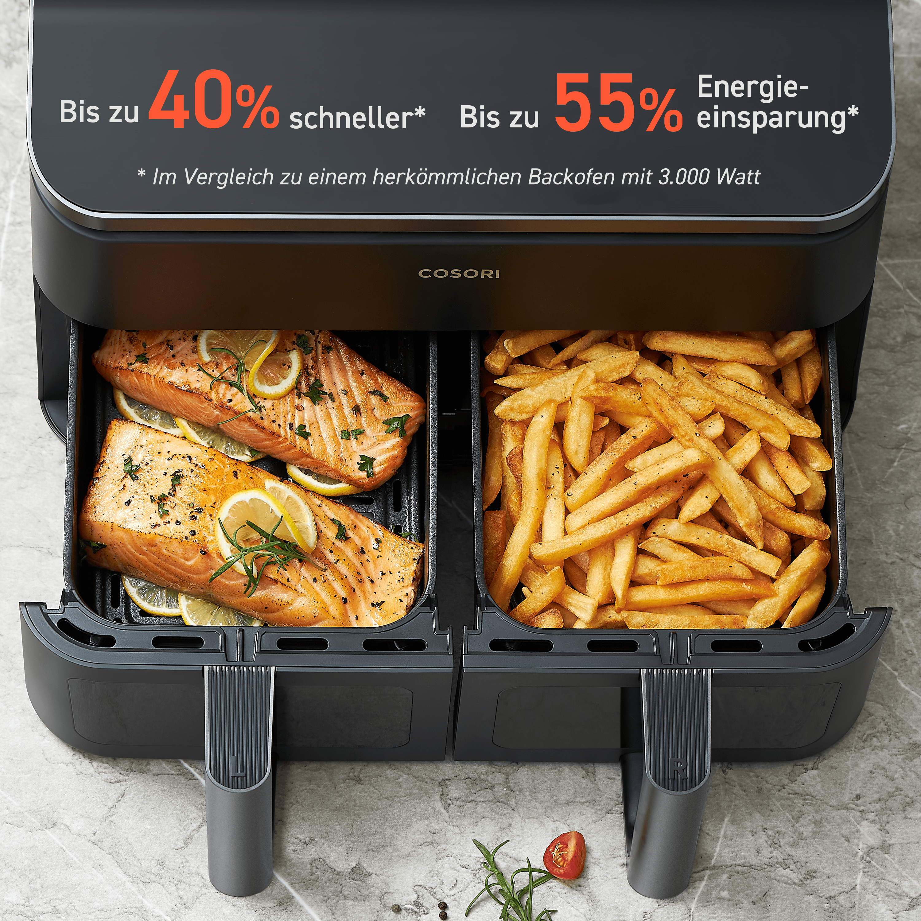 Doppelte Heißluftfritteuse mit Lachs und Pommes. Oben ist Lachs, unten Pommes.