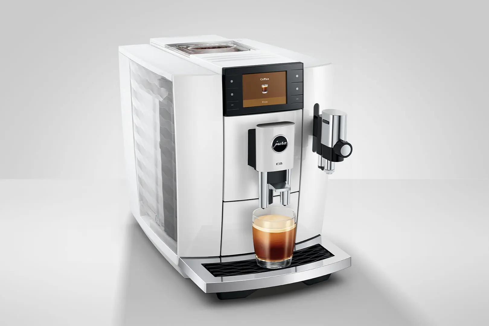Una macchina da caffè bianca prepara un espresso in un bicchiere.