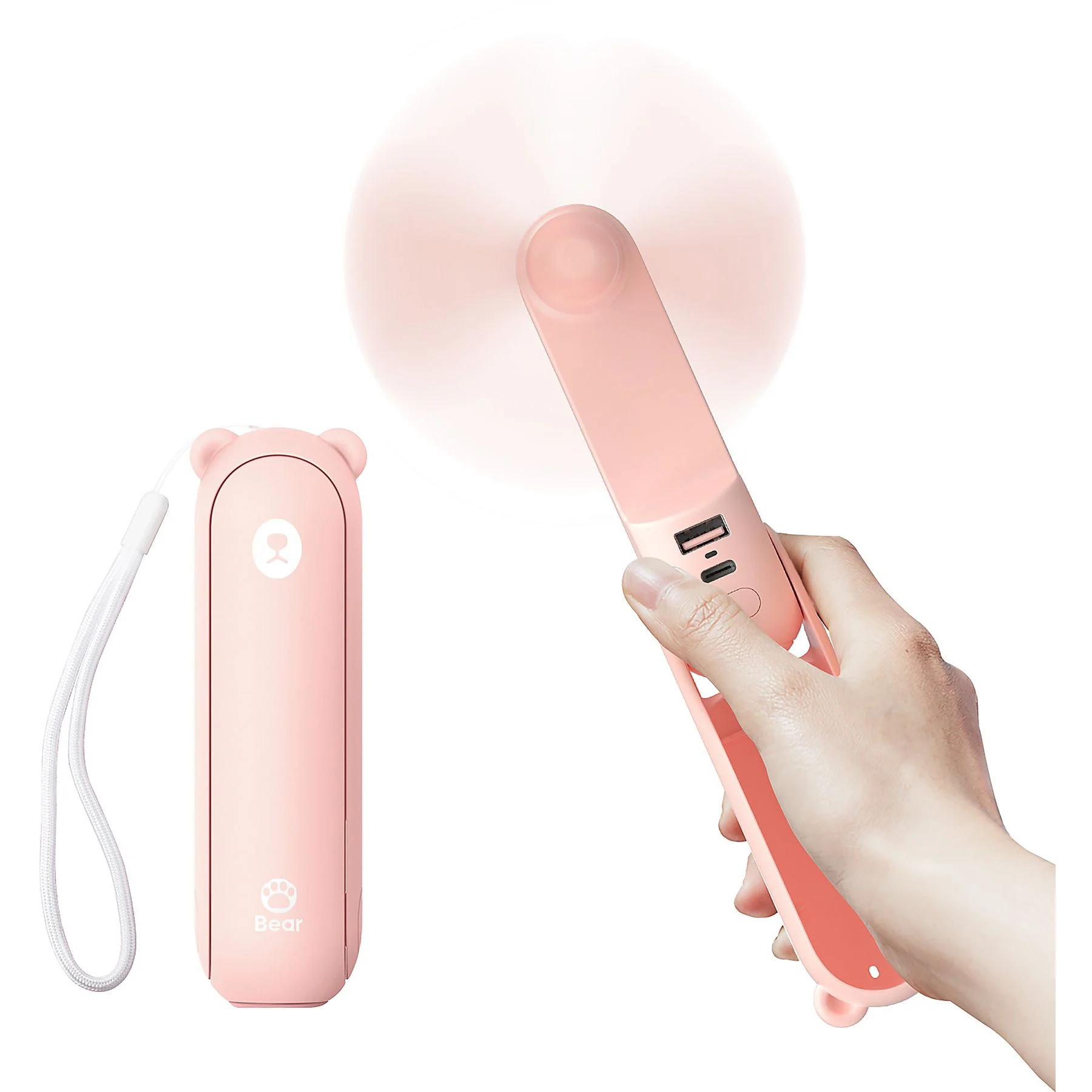 Un ventilador portátil rosa con puertos USB sostenido por una mano. Un ventilador cerrado descansa a su lado.
