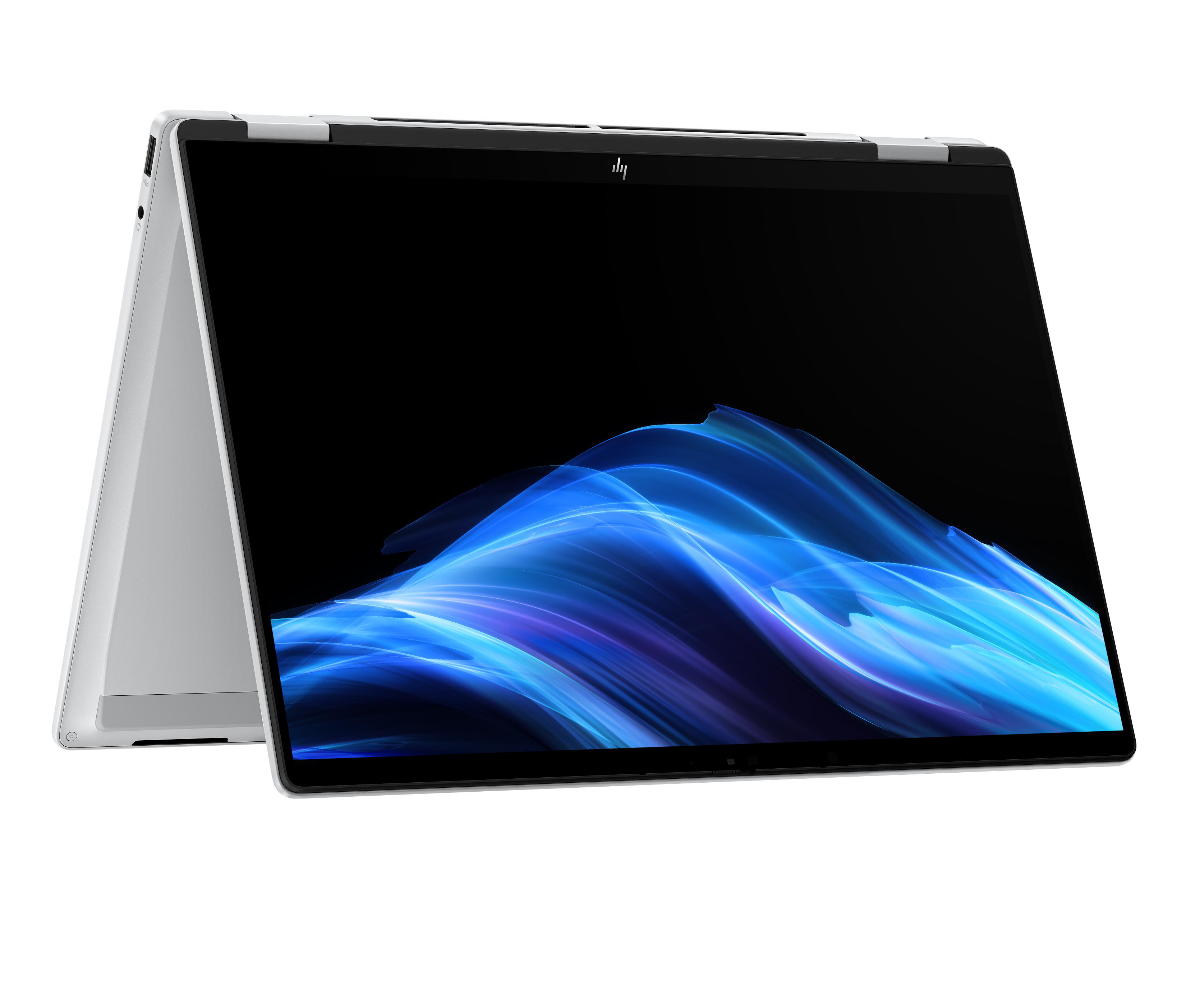 Ein silberner Laptop mit einem dunklen Bildschirm, der abstrakte blaue Wellen zeigt.