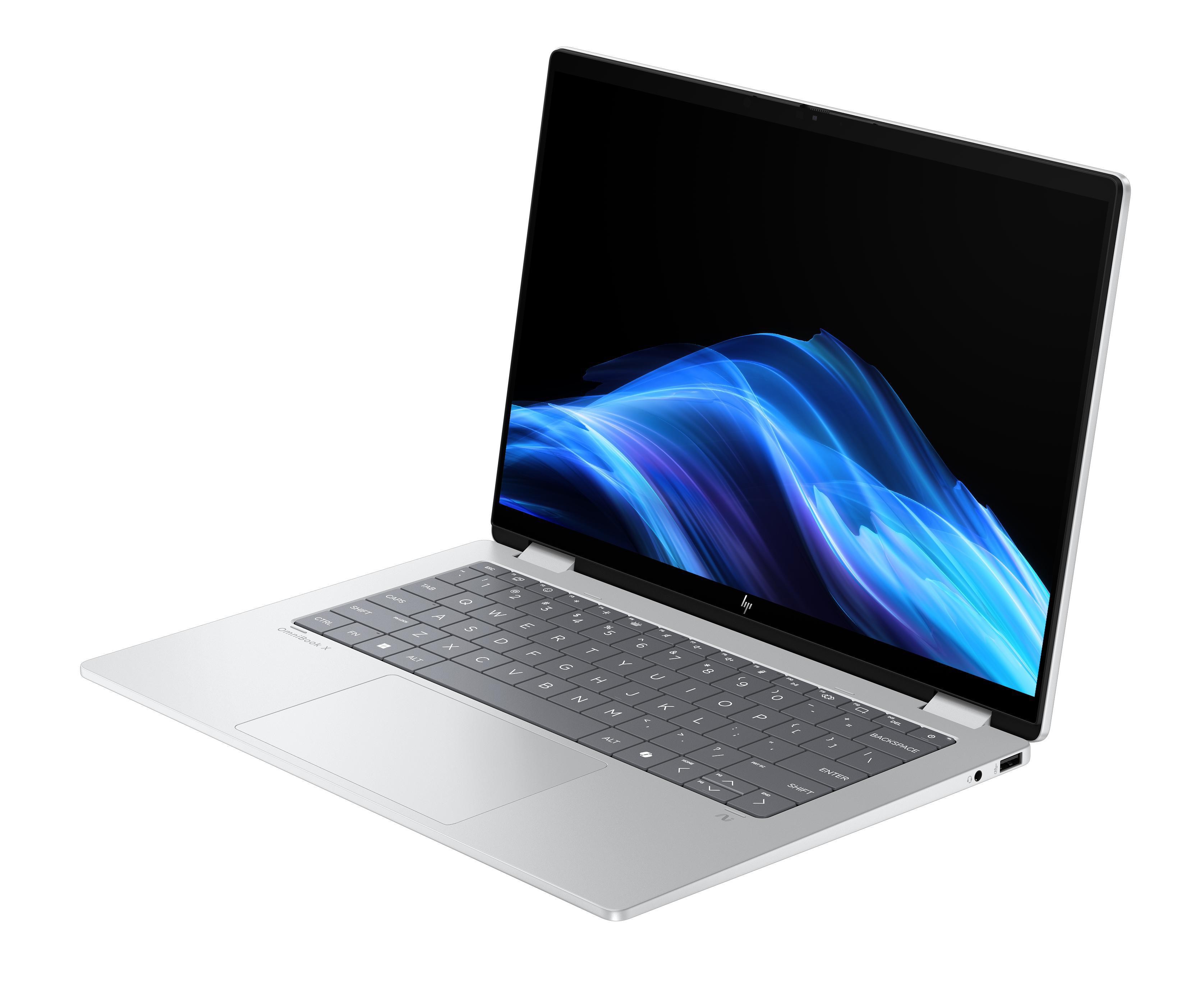 Ein schlankes, silbernes Laptop mit beleuchteter Tastatur und einem blauen abstrakten Hintergrund.