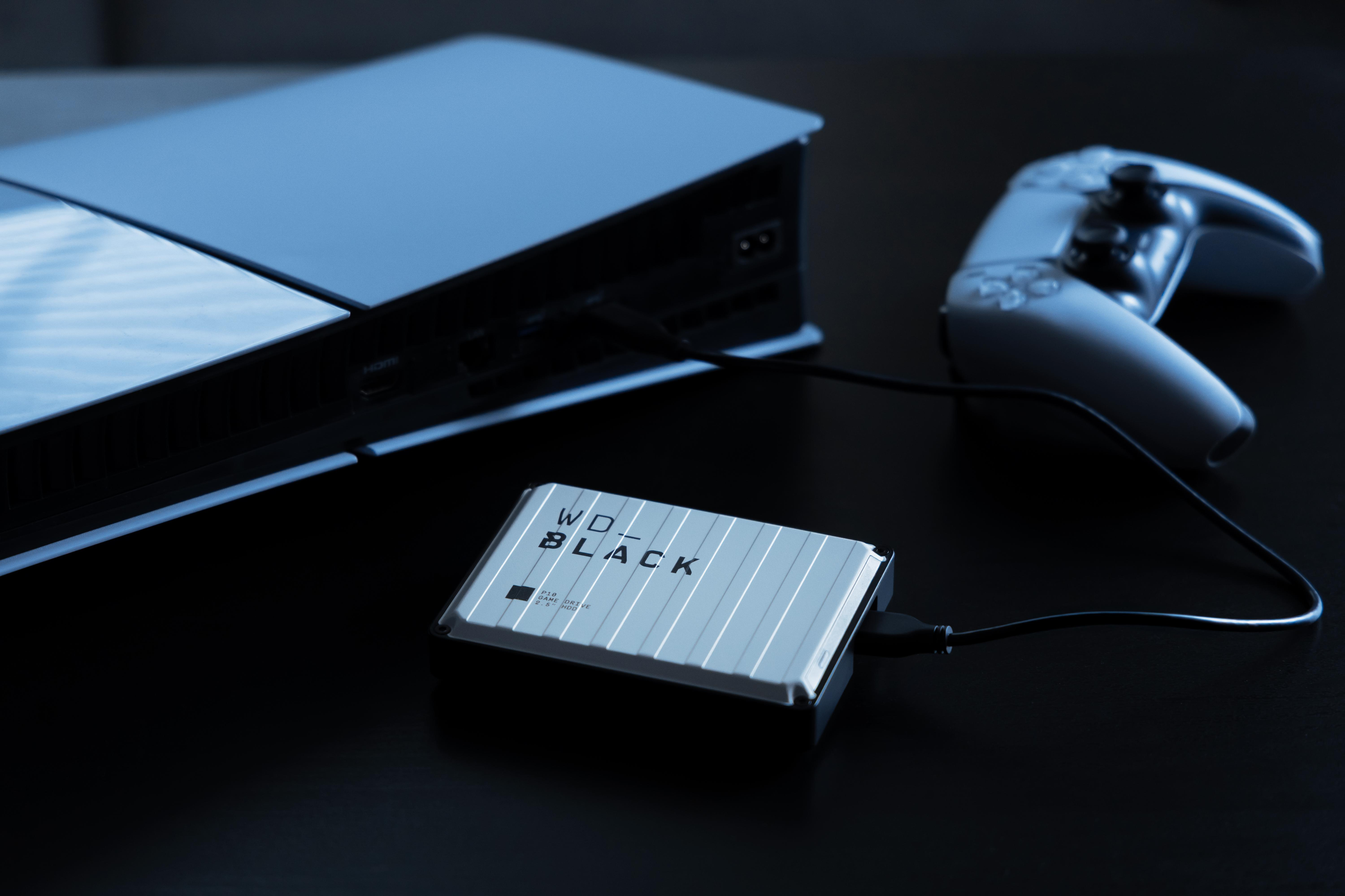 Eine externe WD_BLACK-Festplatte ist an eine Konsole angeschlossen, daneben liegt ein Controller.
