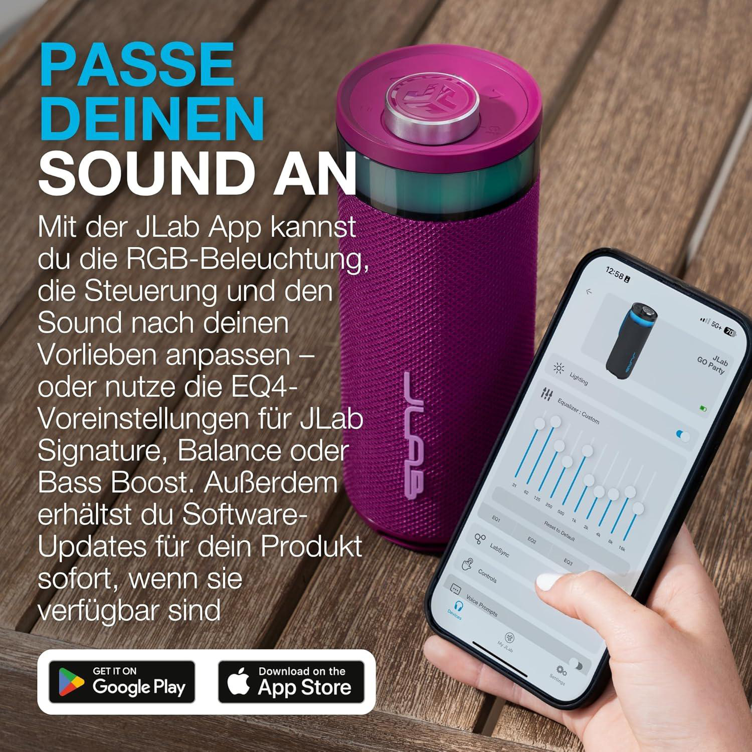 Lila JLab Lautsprecher neben einem Handy, das die JLab App zeigt.