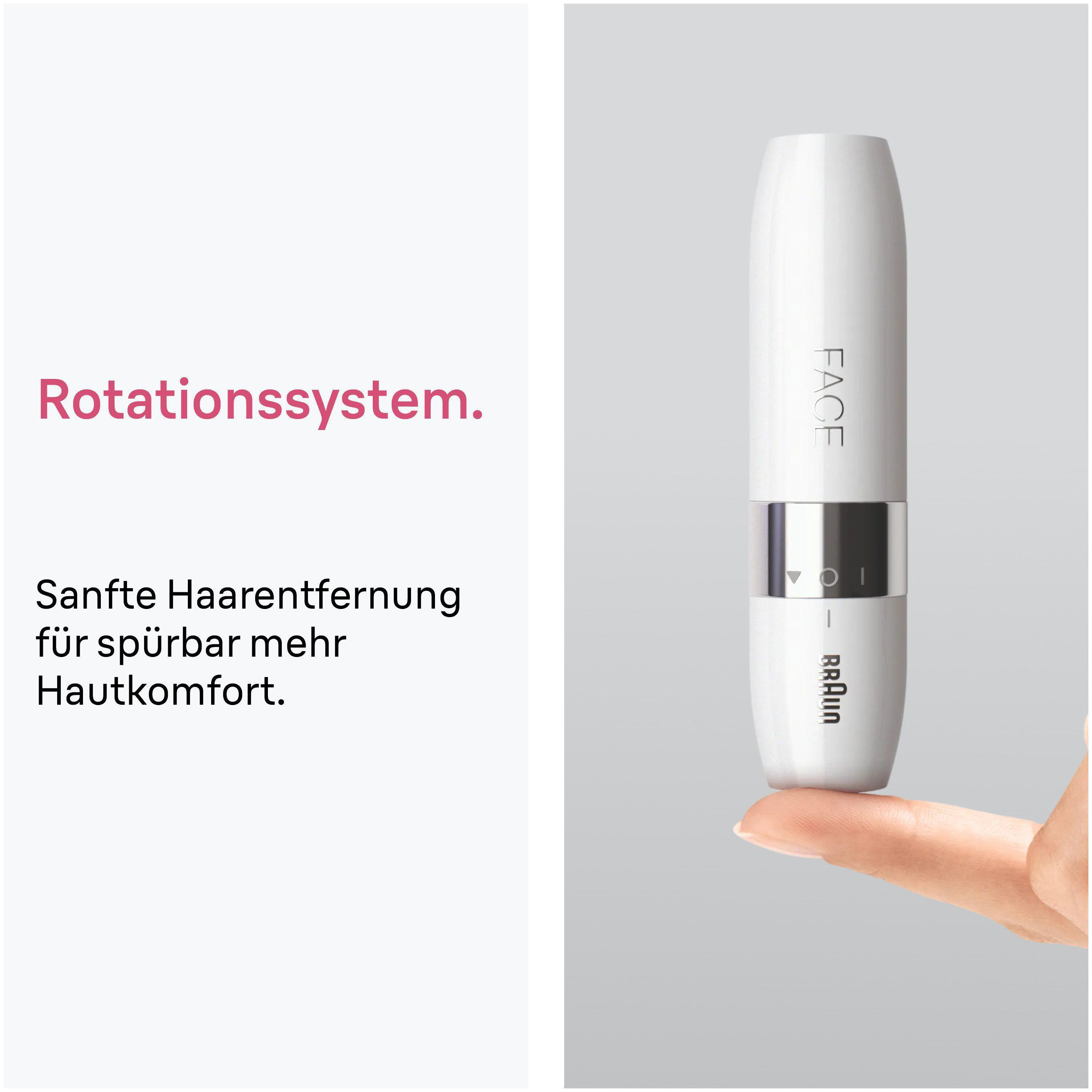 Ein weißer Braun Gesichts-Haarentferner wird auf einem Finger gehalten.