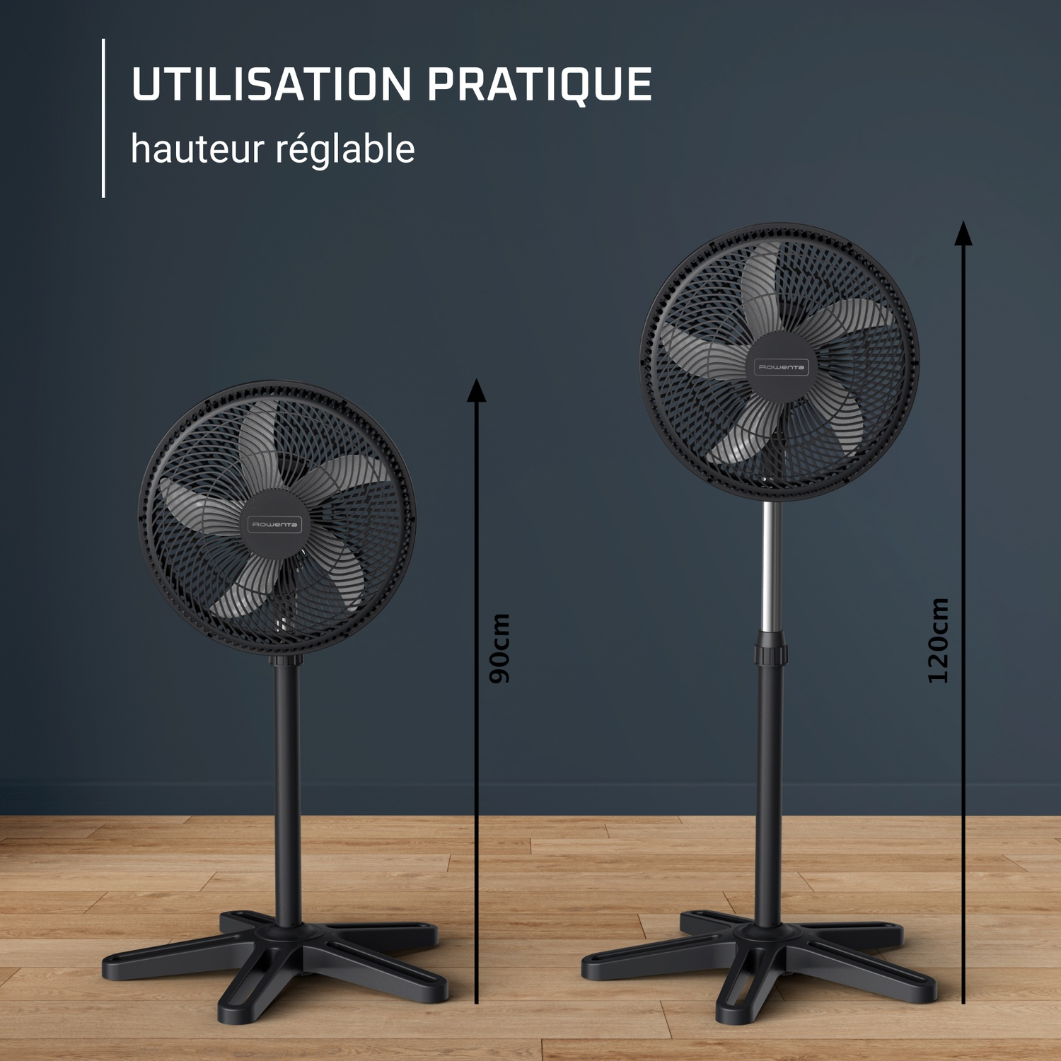 Two black pedestal fans on wood floor, 90cm and 120cm tall.