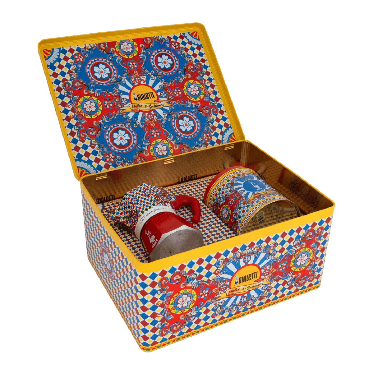 Una cafetera Moka Bialetti roja y una lata en una caja de hojalata decorativa con patrones ornamentados.