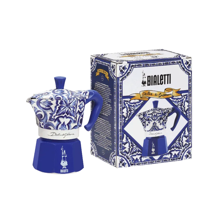 Una cafetera Bialetti azul con diseño floral blanco y su caja a juego.