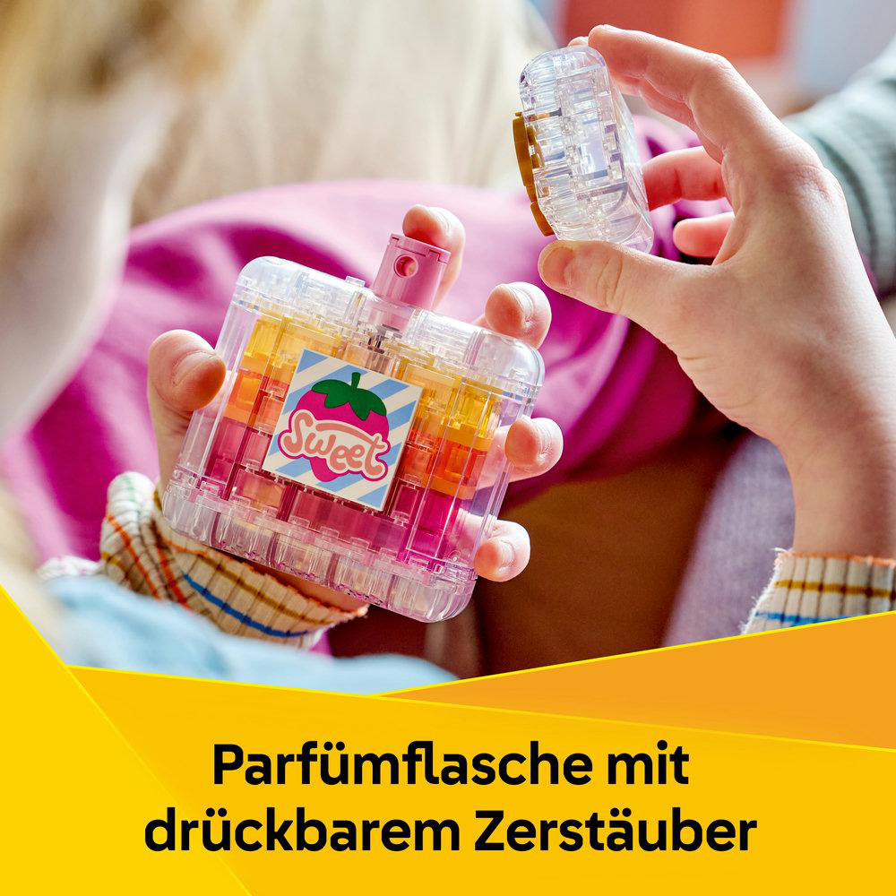 Parfümflasche mit Süßigkeiten-Aufkleber und pinkem Sprühkopf.