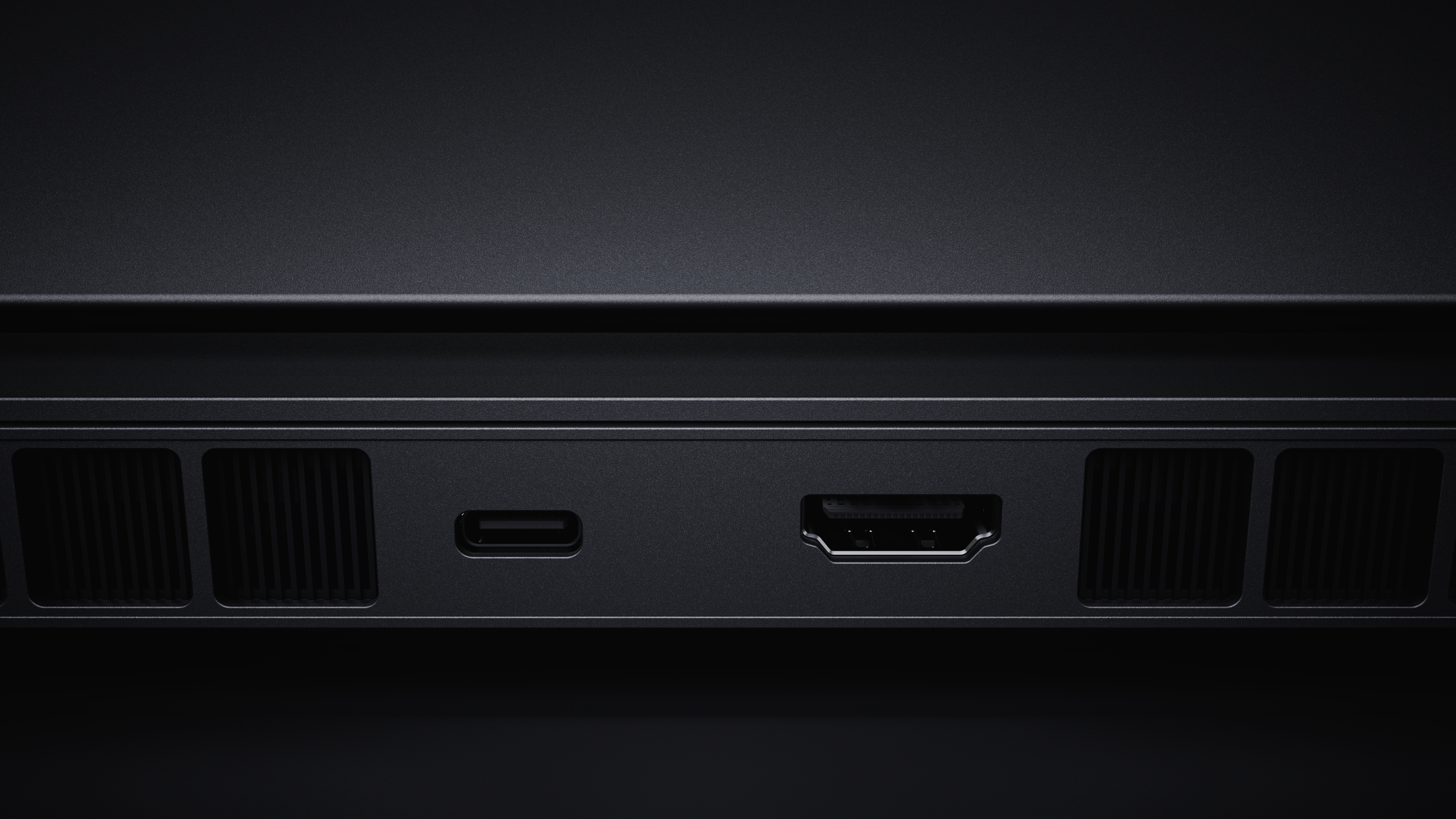 Zbliżenie na czarne otwory wentylacyjne, port USB-C i HDMI na urządzeniu.