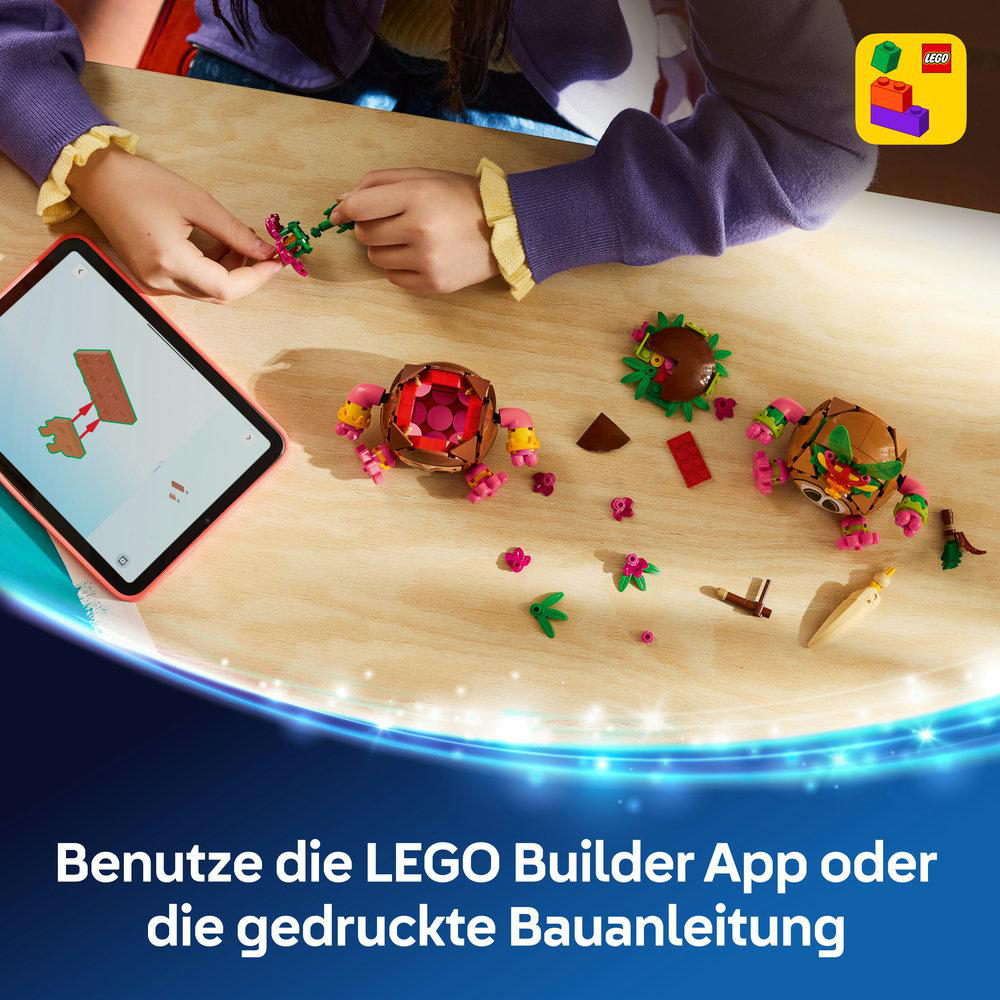 Kind baut mit bunten Legosteinen und Tablet.