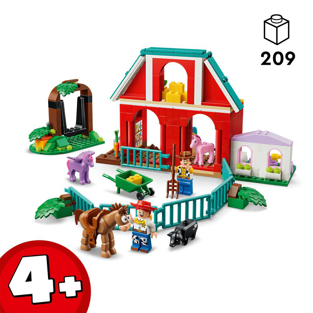 Ein Spielzeugbauernhof-Set mit rot-blauer Scheune, Tieren und Figuren.
