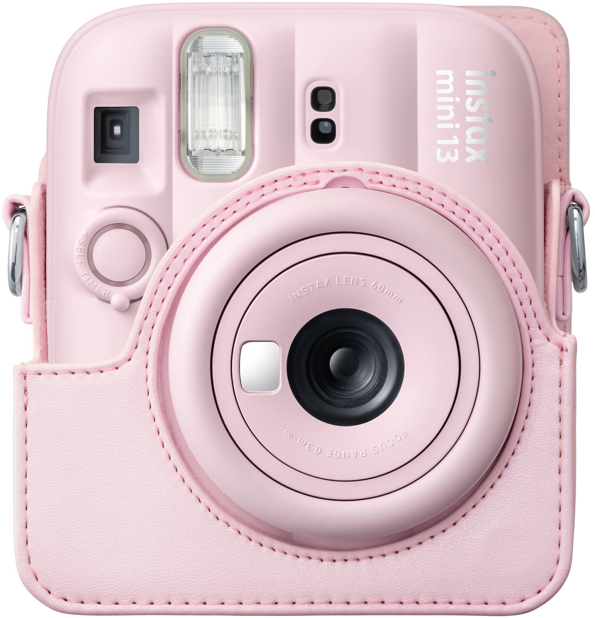 Un appareil photo instantané rose avec un étui et un objectif assortis.