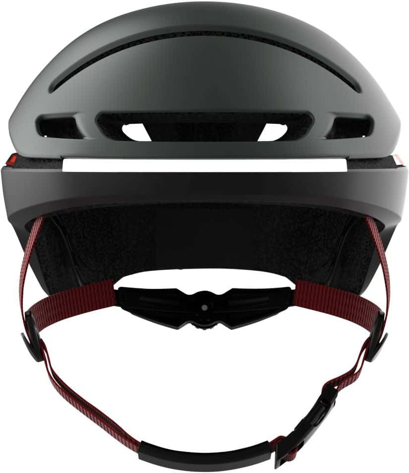 Draufsicht eines grauen Fahrradhelms mit roten Gurten und schwarzem Riemen.