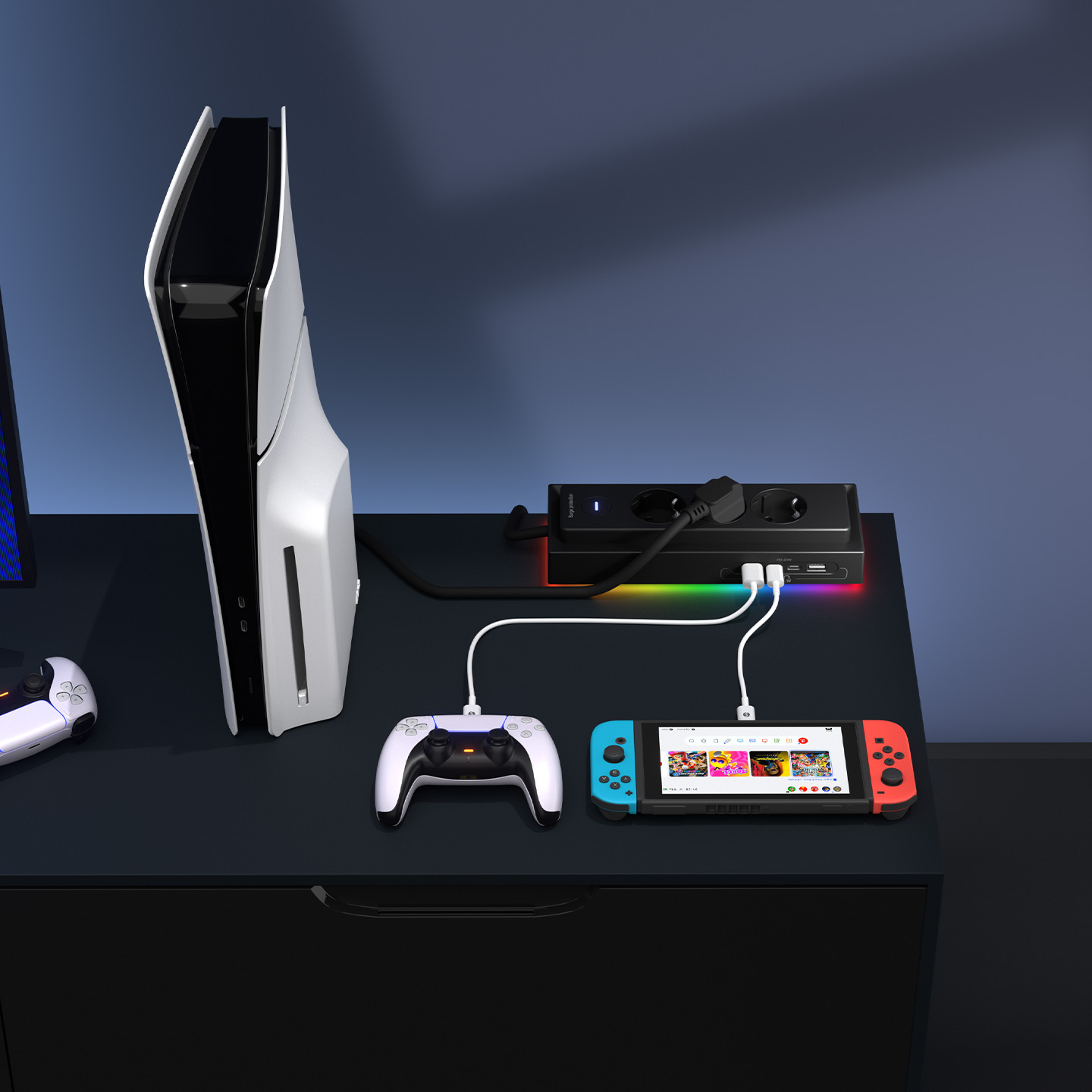 Beyaz bir PS5, kontrolcü ve Nintendo Switch siyah bir masada, çoklu prize bağlı.