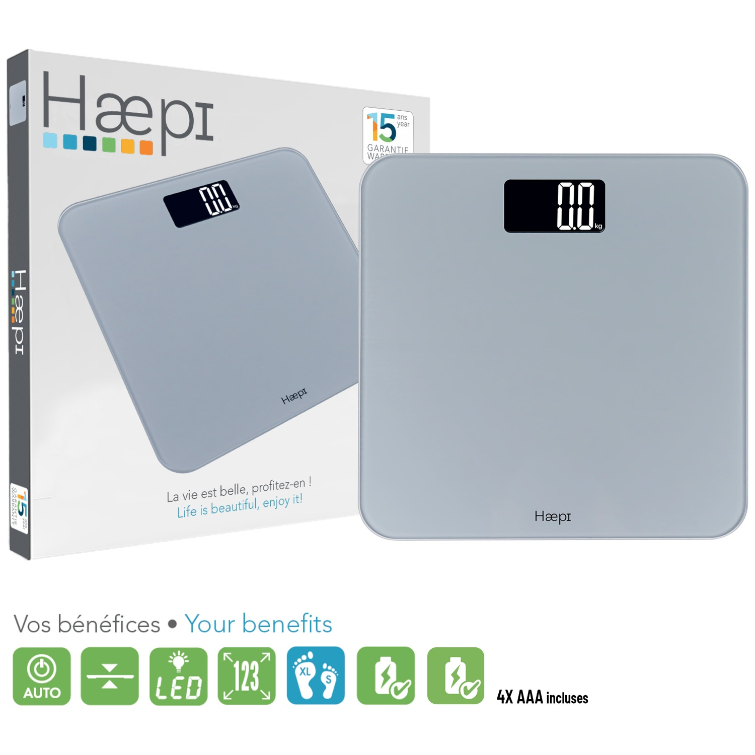 A gray glass scale with a digital display and its packaging. It shows 0.0 kg.