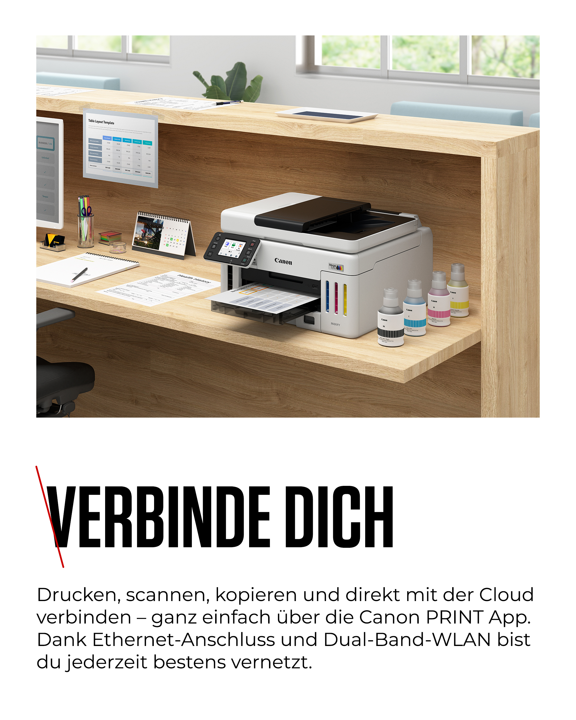 Ein Canon Drucker mit Tintenflaschen steht auf einem Schreibtisch.