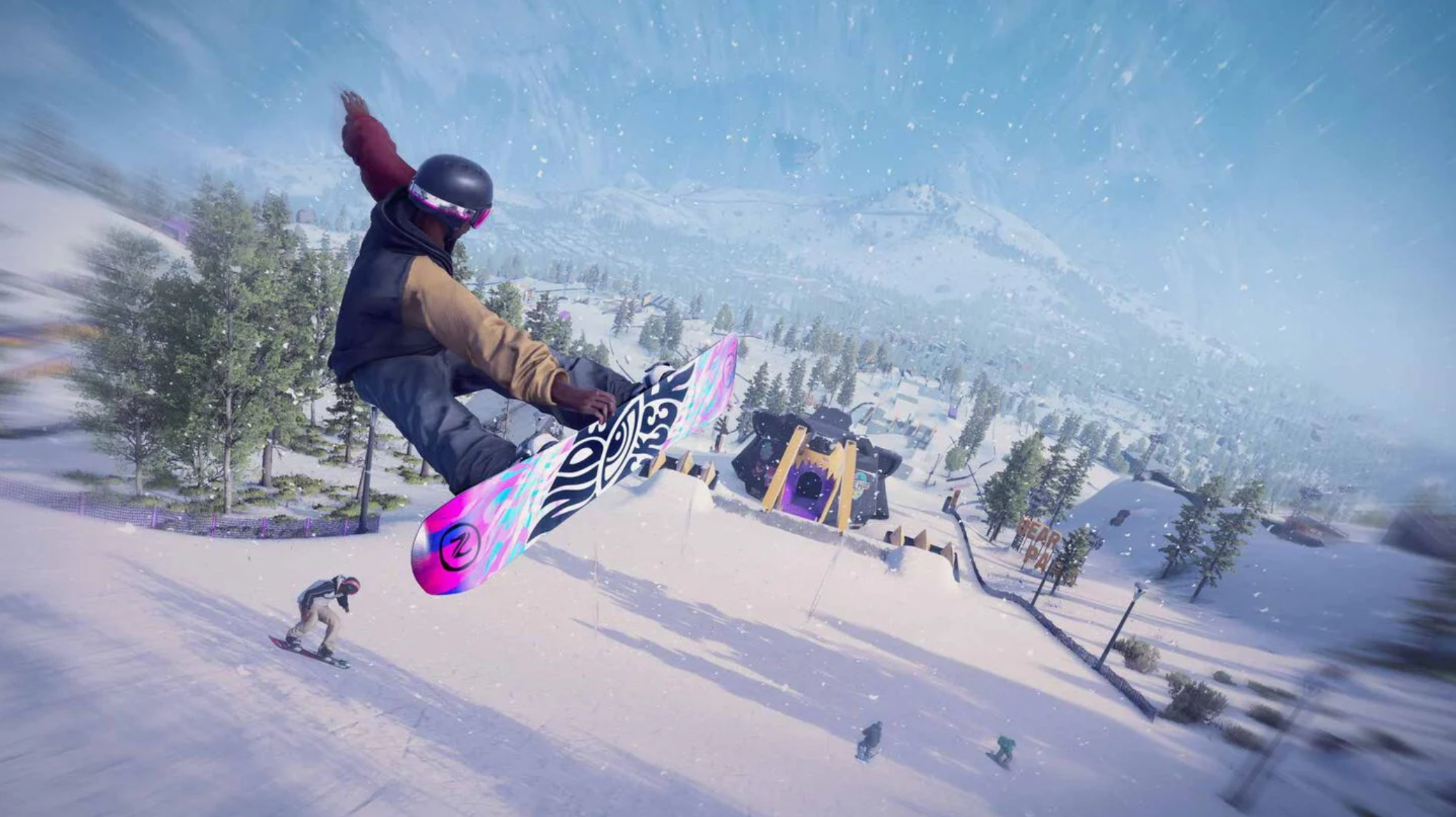 Un snowboarder salta en el aire, con árboles y montañas al fondo.