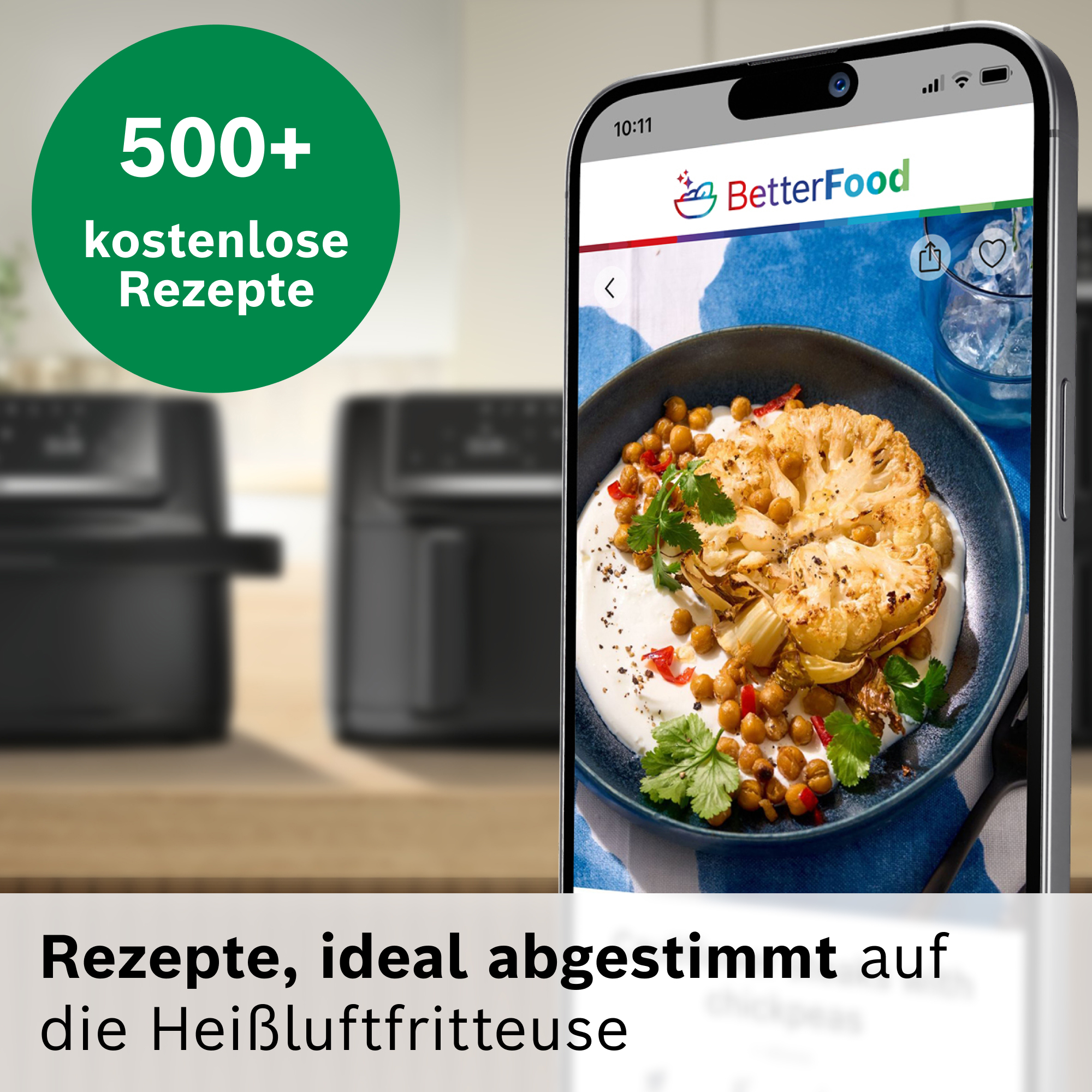 Eine App zeigt ein Gericht mit Blumenkohl und Kichererbsen, neben Heißluftfritteusen.