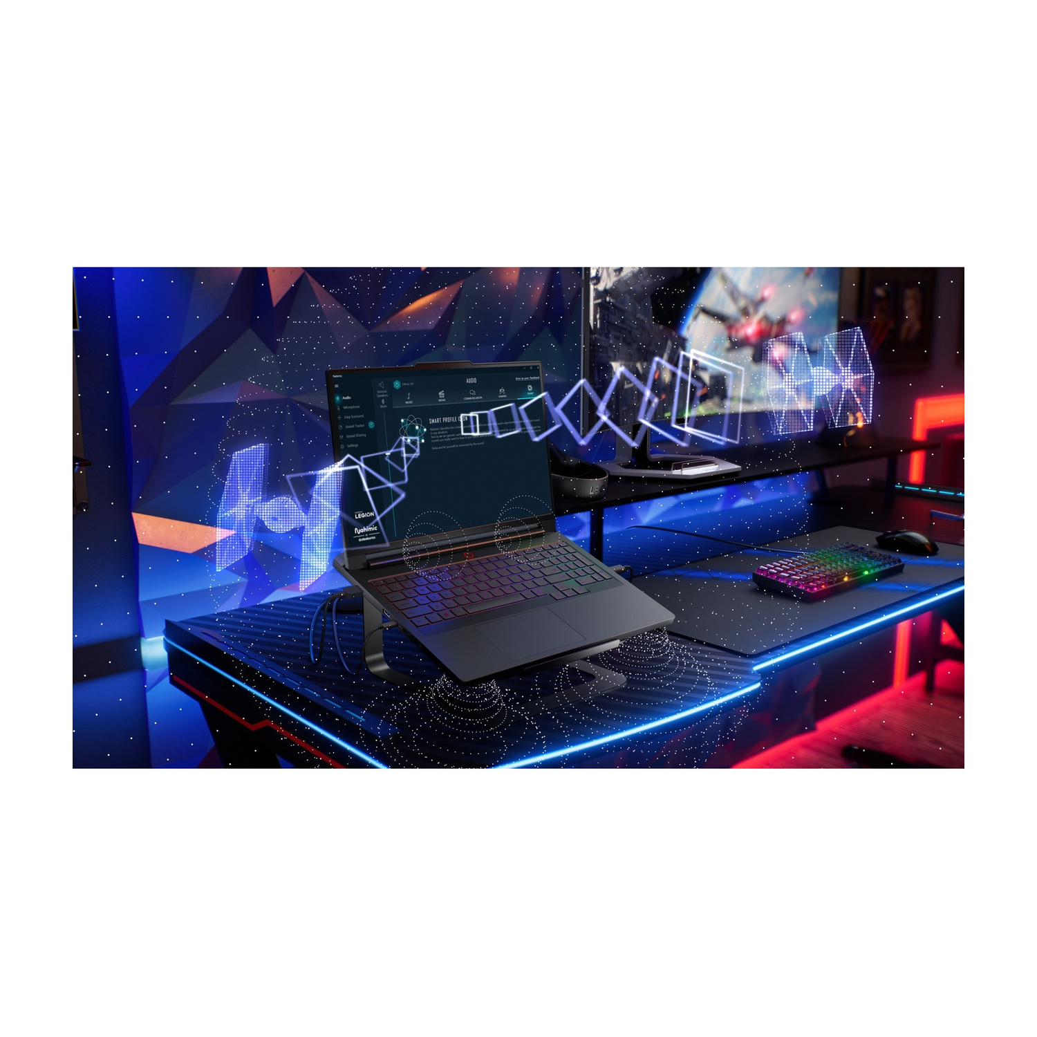 Un laptop su una scrivania con illuminazione RGB. Sullo sfondo è visibile un grande monitor.