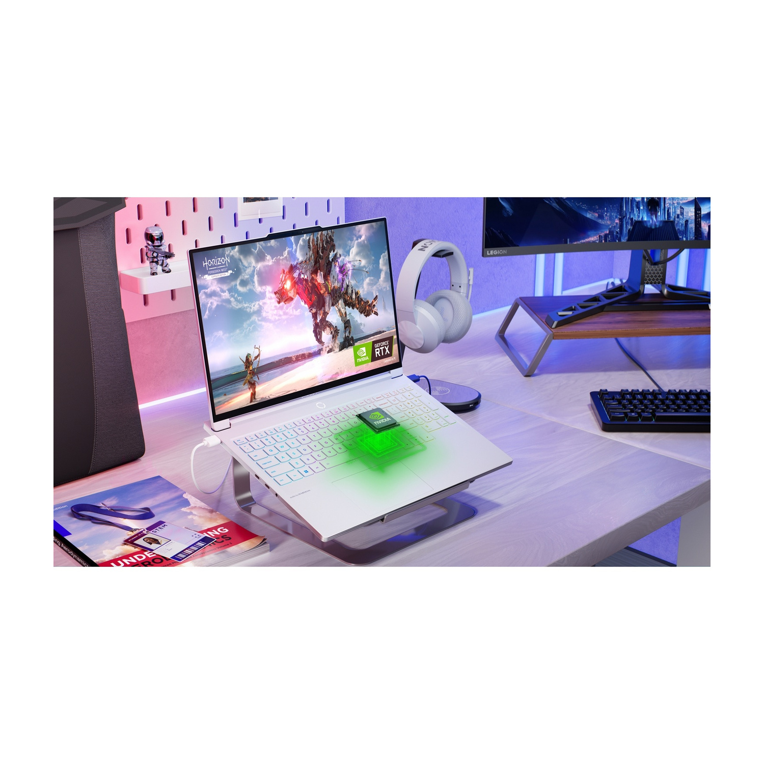 Un laptop inclinato con tastiera illuminata, cuffie e un libro nelle vicinanze.
