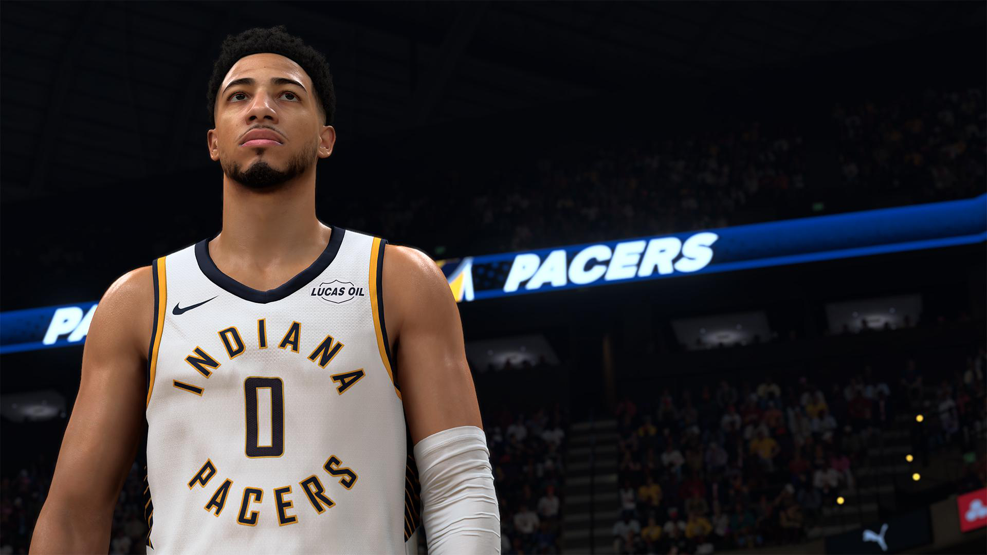 Ein Basketballspieler im weißen Trikot mit der Nummer 0 schaut nach oben. "PACERS" leuchtet im Hintergrund.