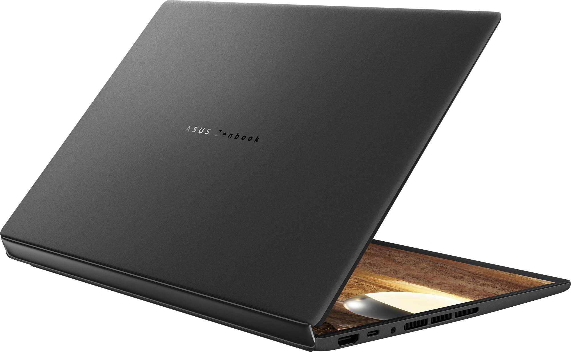 Egy zárt, sötét Asus Zenbook laptop megvilágított képernyővel.