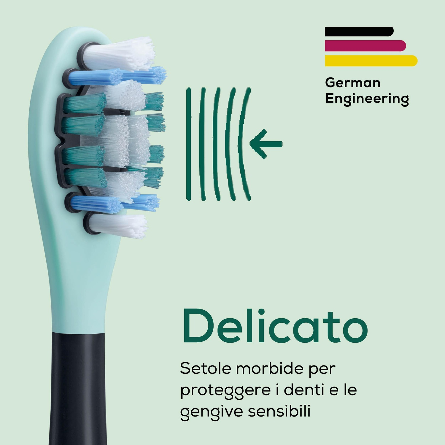 Primo piano di uno spazzolino da denti con manico verde chiaro e setole multicolori.