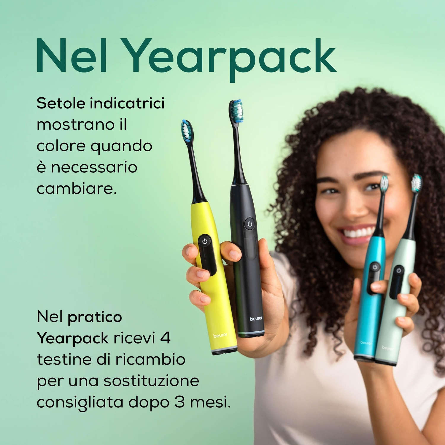 Una donna tiene spazzolini elettrici gialli, neri, turchesi e verde menta.