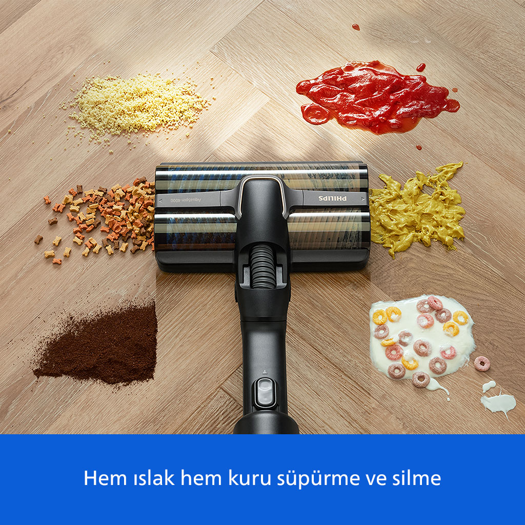 Ahşap zeminde ketçap, tahıl, kahve ve evcil hayvan mamasıyla çevrili elektrikli süpürge başlığı.