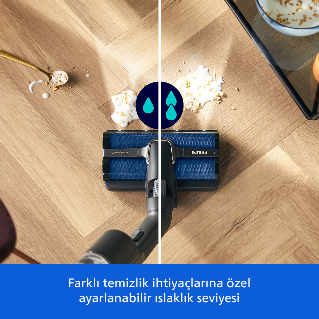 Ahşap zemindeki dökülmüş mısır gevreği ve sütü temizleyen süpürge.