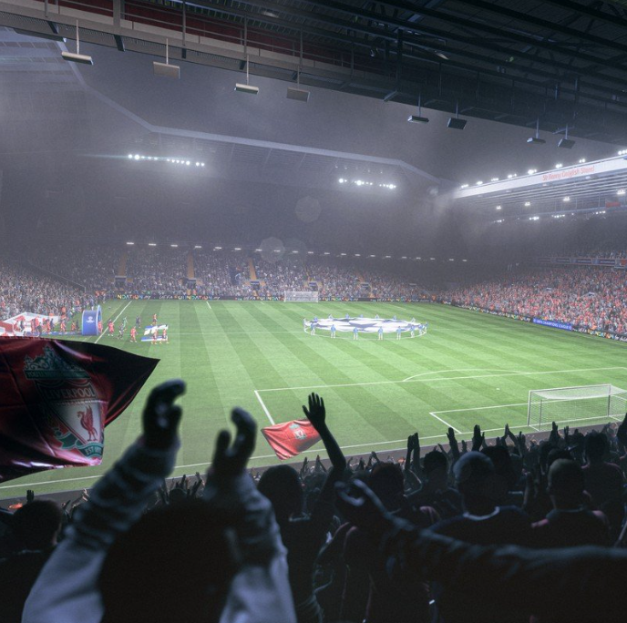 Vista de un estadio de fútbol lleno con aficionados y jugadores en el campo iluminado.