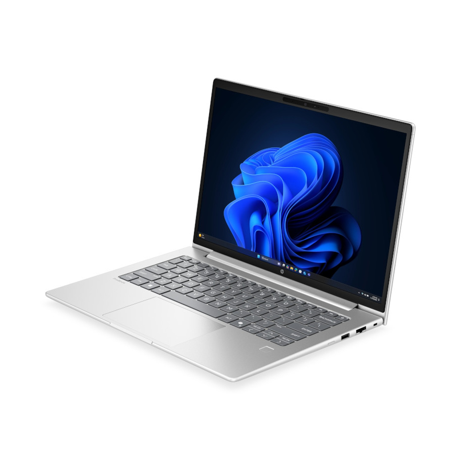Un computer portatile argentato con una grafica a onde blu sullo schermo, fotografato su sfondo bianco.
