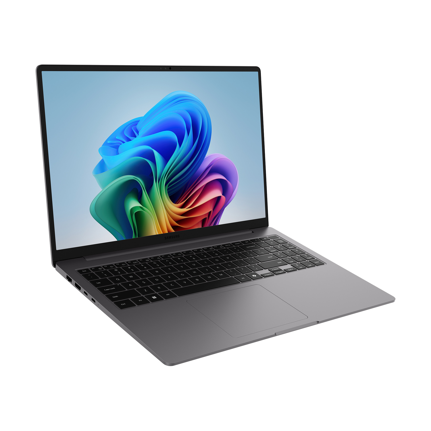 Un laptop Samsung grigio su superficie bianca, che mostra uno sfondo astratto e colorato.