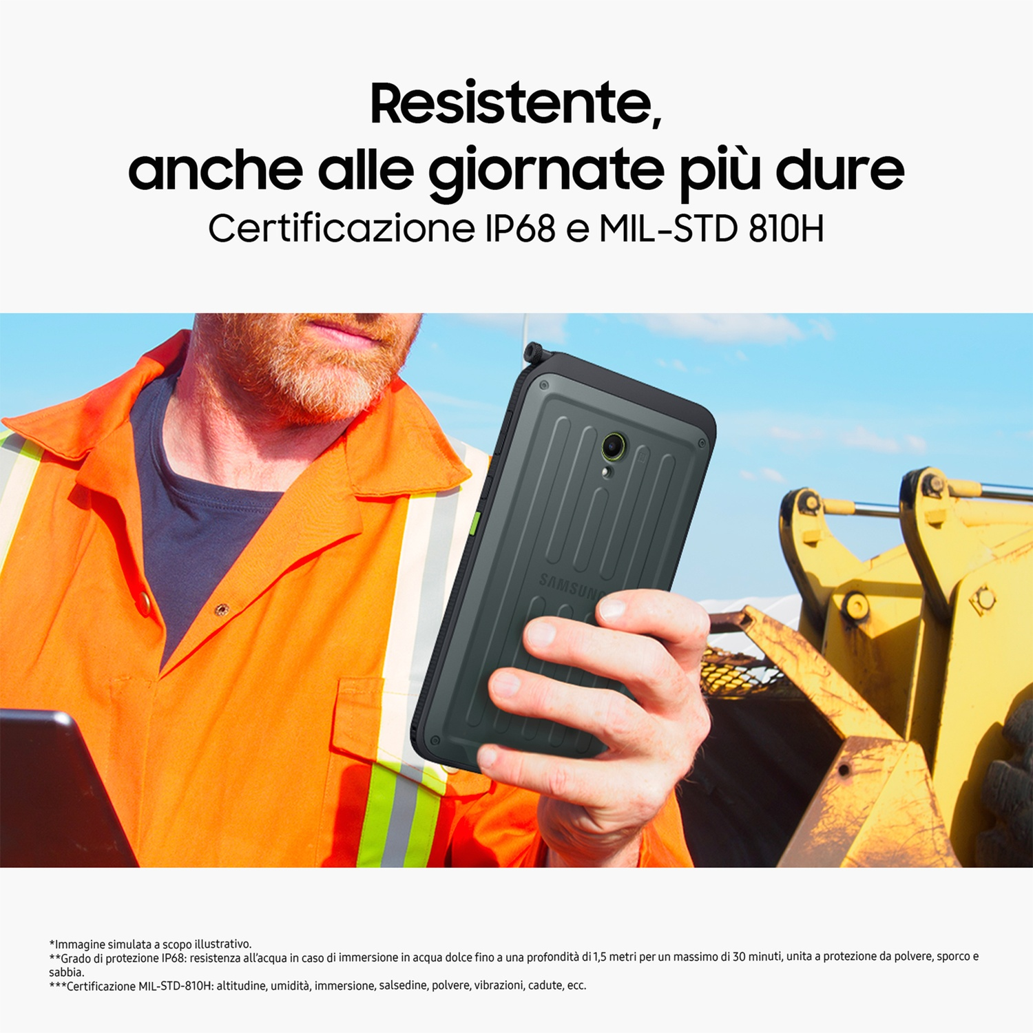 Operaio edile che tiene in mano uno smartphone rugged grigio.