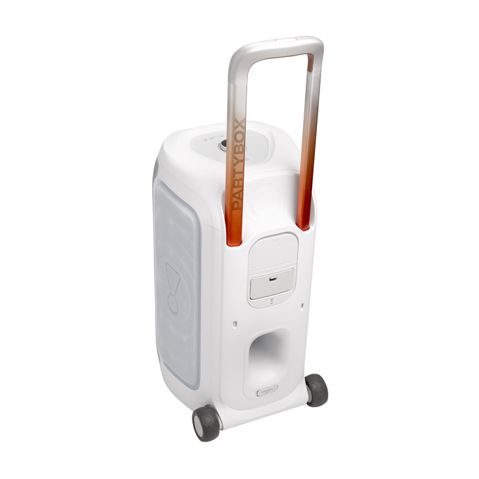 Un altavoz portátil JBL PartyBox blanco con asa degradada naranja y ruedas sobre fondo negro.