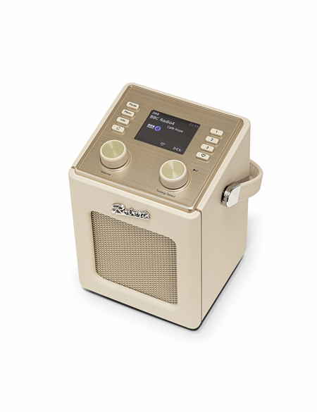 Ein beiges Retro-Radio mit goldfarbenem Bedienfeld, Knöpfen und einem Bildschirm auf der Oberseite.