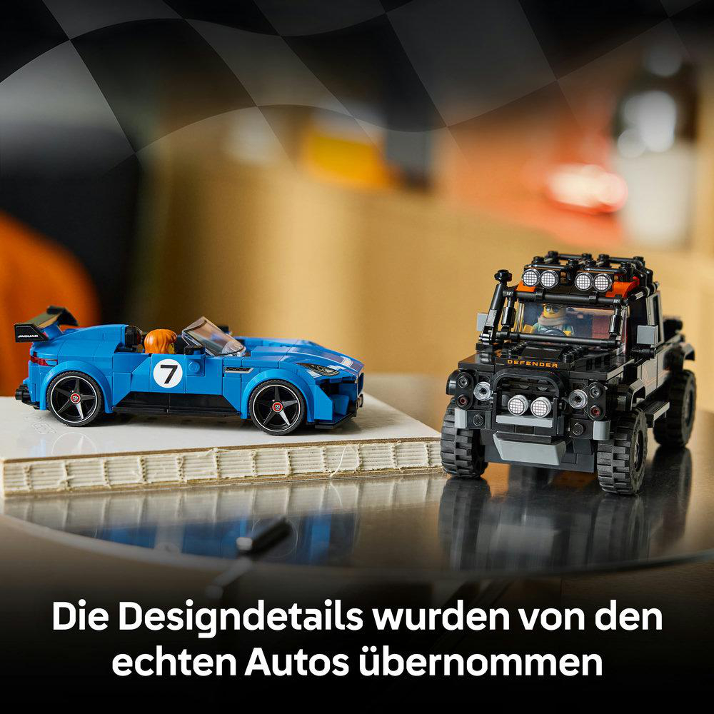Zwei LEGO-Spielzeugautos: ein blauer Jaguar Rennwagen und ein schwarzer Land Rover Defender auf glänzender Oberfläche.