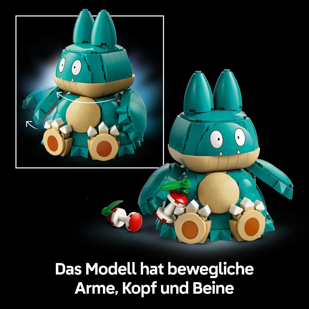 Eine grüne und beige Pokémon-Figur aus Kleusteinen hält eine Beere, mit beweglichen Armen, Kopf und Beinen.