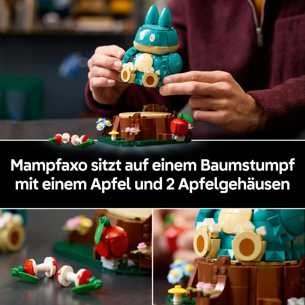 Eine Person baut eine grüne Lego-Figur über einem Baumstumpf mit Äpfeln und Blumen.