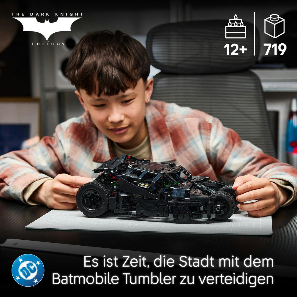 Ein Junge baut ein schwarzes Lego Batmobile Tumbler Modell zusammen.