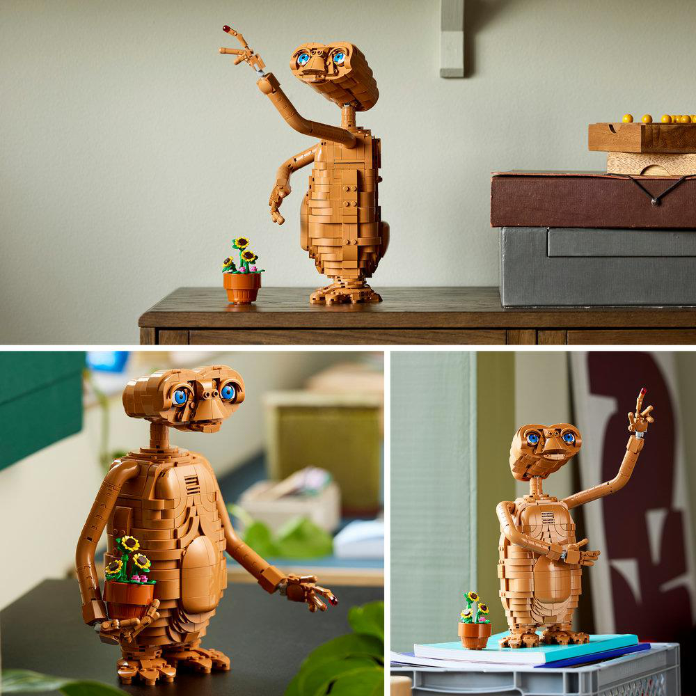 Eine aus Lego-Steinen gebaute E.T.-Figur steht auf einem Tisch neben einem winzigen Blumentopf.